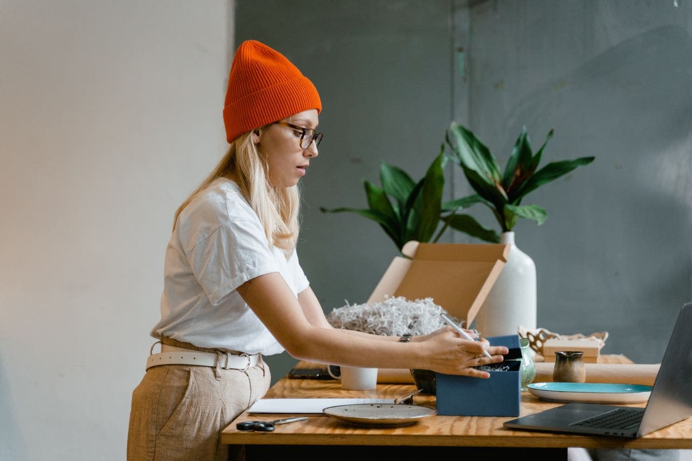 A small business owner packing an order at their desk